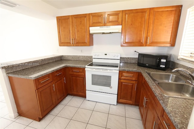 kitchen with a sink, brown cabinetry, under cabinet range hood, black microwave, and white range with electric stovetop