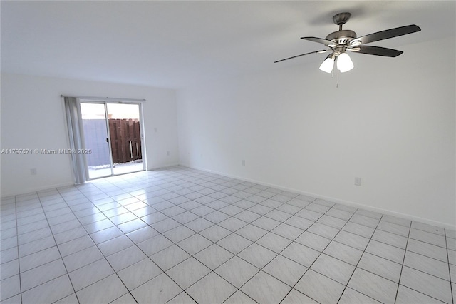 empty room with light tile patterned floors and a ceiling fan