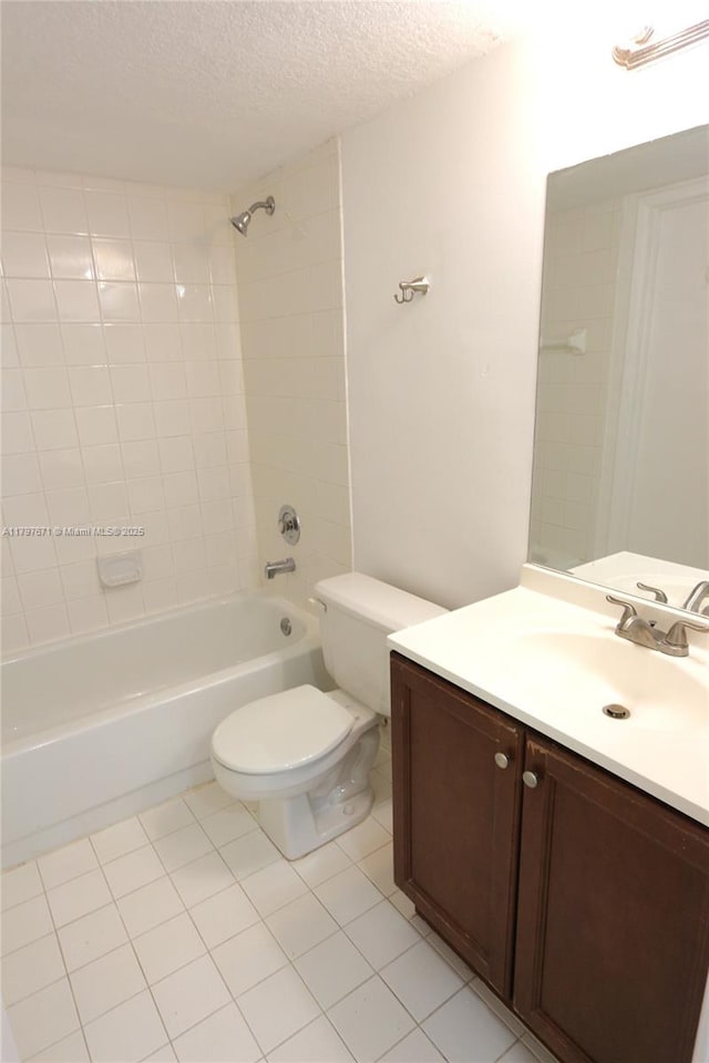 bathroom with toilet, vanity, a textured ceiling, tile patterned floors, and tub / shower combination