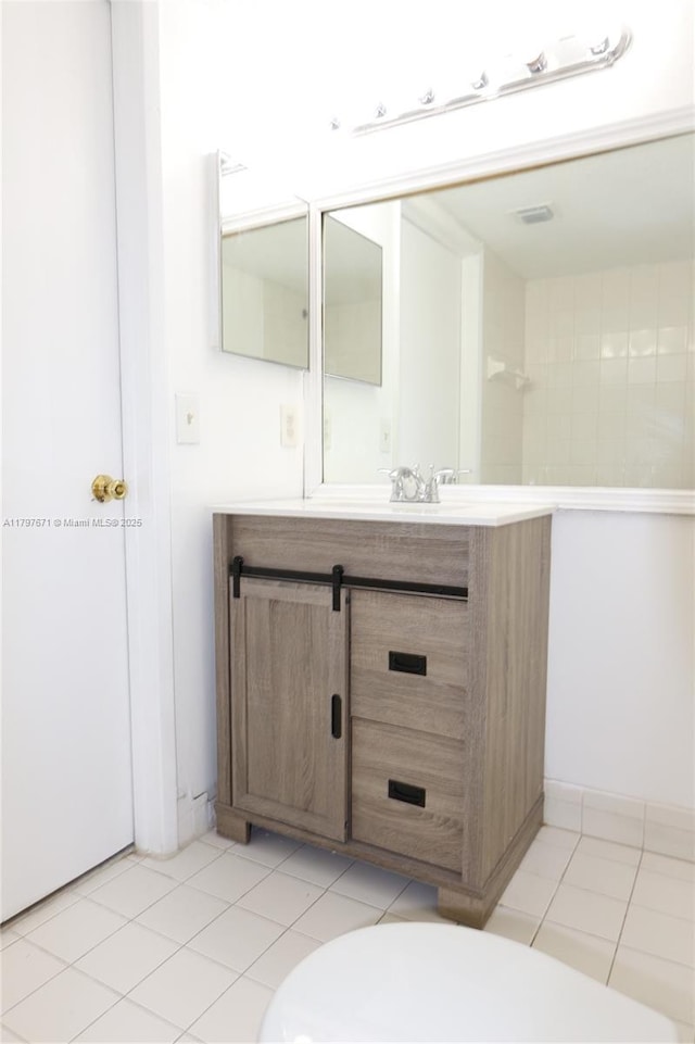 bathroom featuring toilet, tile patterned flooring, and vanity