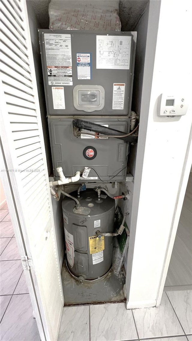utility room featuring electric water heater and heating unit
