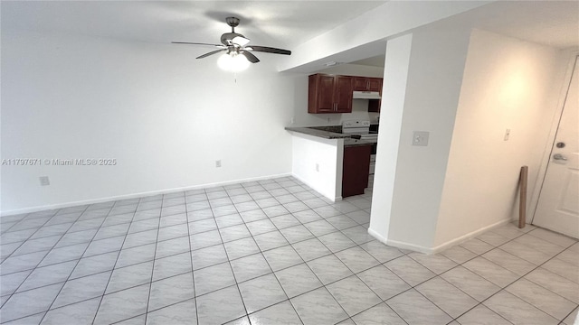 interior space featuring light tile patterned floors, white electric stove, ceiling fan, a peninsula, and dark countertops