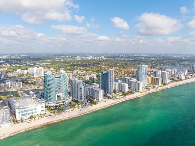 aerial view featuring a water view, a city view, and a beach view