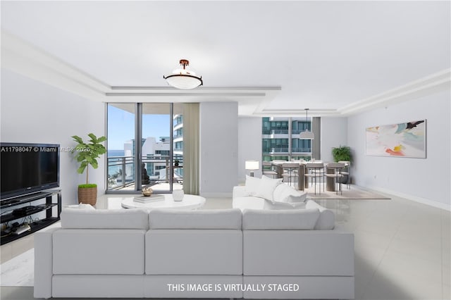 tiled living area with baseboards, a raised ceiling, and floor to ceiling windows