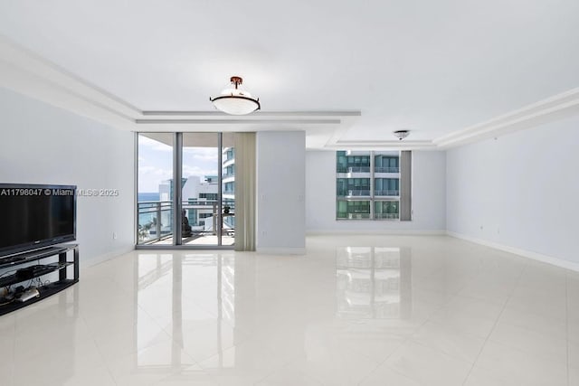 tiled living room featuring baseboards, a wall of windows, and a tray ceiling