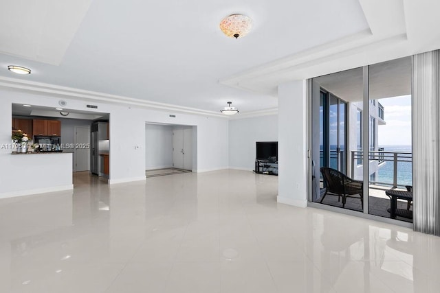 unfurnished living room featuring floor to ceiling windows, light tile patterned floors, visible vents, and baseboards