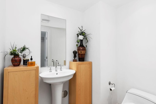 bathroom with toilet and visible vents