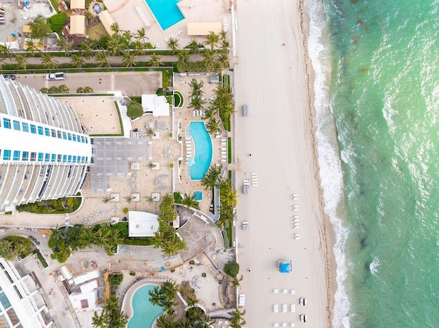 birds eye view of property with a beach view and a water view