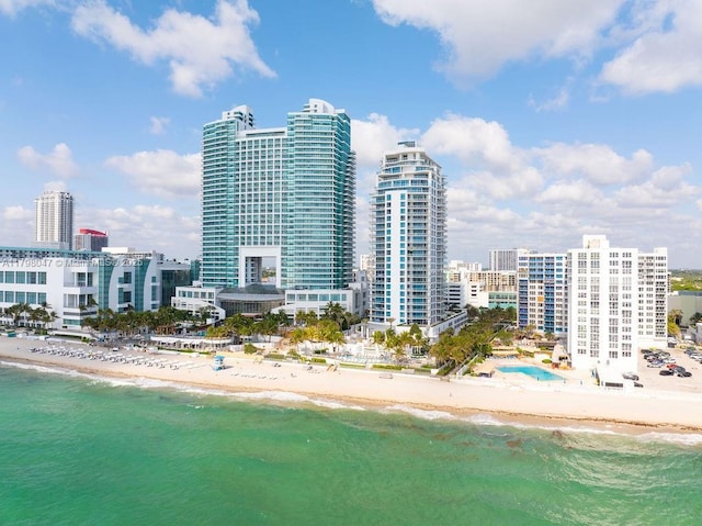 drone / aerial view with a water view and a view of the beach