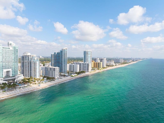 aerial view featuring a beach view, a water view, and a view of city