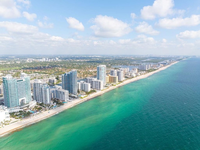 birds eye view of property with a water view, a beach view, and a view of city