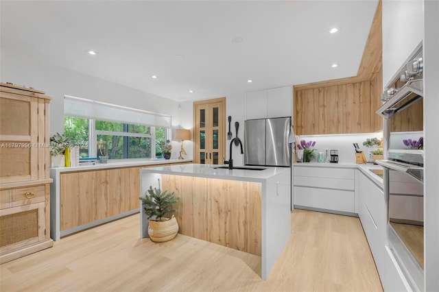 7560 SW 144th St, Palmetto Bay, FL 33158 - kitchen featuring light wood finished floors, double oven, modern cabinets, and a sink