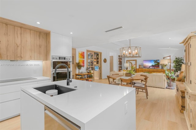 7560 SW 144th St, Palmetto Bay, FL 33158 - kitchen with light wood finished floors, a fireplace, open floor plan, and a sink