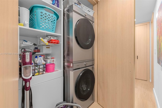 7560 SW 144th St, Palmetto Bay, FL 33158 - clothes washing area featuring laundry area, stacked washer / dryer, and wood finished floors