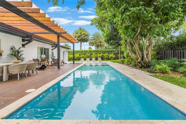 7560 SW 144th St, Palmetto Bay, FL 33158 - view of swimming pool with a pergola, a fenced backyard, a wooden deck, and a fenced in pool