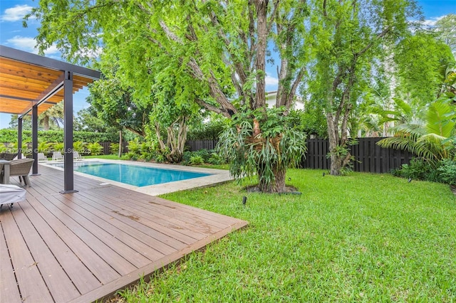7560 SW 144th St, Palmetto Bay, FL 33158 - view of pool featuring a lawn, a wooden deck, a fenced in pool, and a fenced backyard