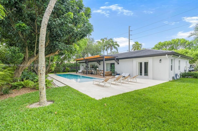7560 SW 144th St, Palmetto Bay, FL 33158 - rear view of property featuring a patio area, french doors, an outdoor pool, a yard, and stucco siding