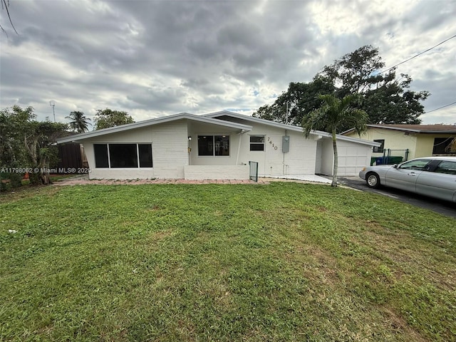 7410 Granada Blvd, Miramar, FL 33023 - view of front of home featuring an attached garage, driveway, and a front lawn