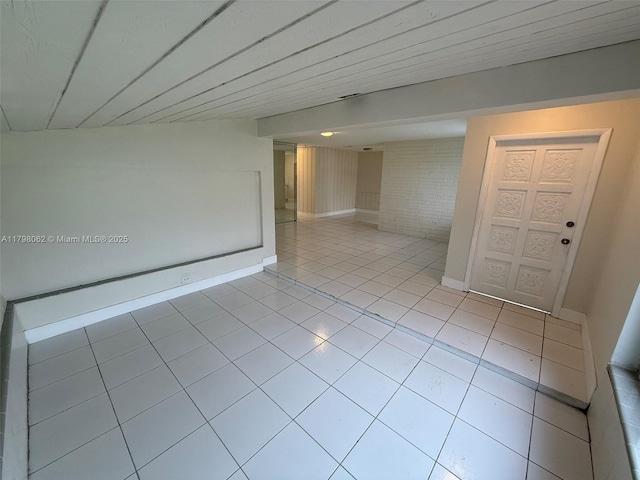 unfurnished room with light tile patterned floors and baseboards