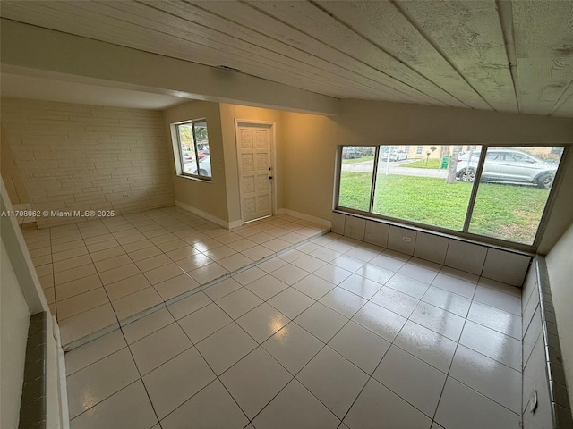 interior space with light tile patterned floors and baseboards