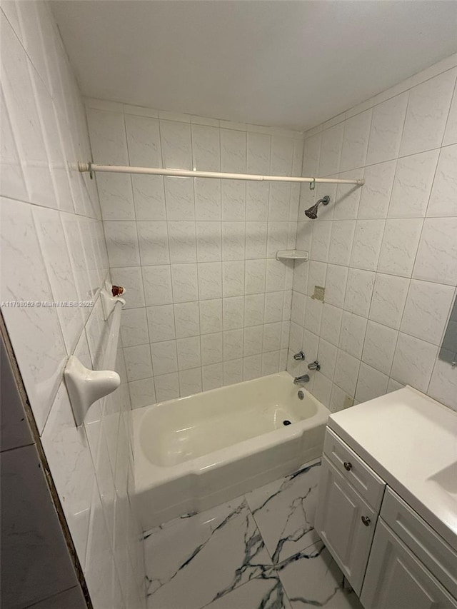 full bathroom featuring vanity, tile walls, tub / shower combination, and marble finish floor