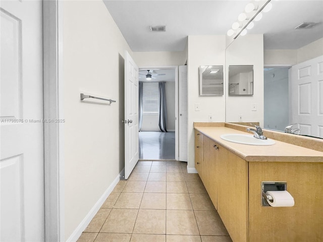 bathroom with vanity, visible vents, tile patterned flooring, ceiling fan, and baseboards