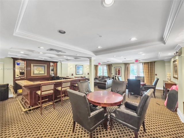 dining room with baseboards, a raised ceiling, visible vents, and crown molding