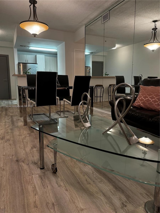 185 SE 14th Ter Unit 1812, Miami, FL 33131 - dining area with wood finished floors and a textured ceiling