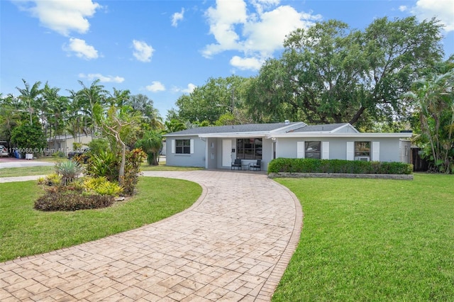 1100 N 31st Ct, Hollywood, FL 33021 - view of front of home with curved driveway, a front lawn, and stucco siding