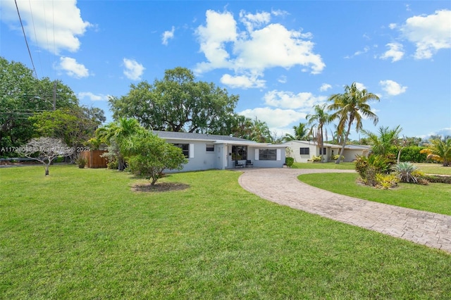 1100 N 31st Ct, Hollywood, FL 33021 - back of house featuring decorative driveway and a yard
