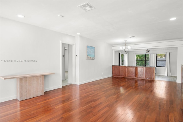 1100 N 31st Ct, Hollywood, FL 33021 - unfurnished living room featuring a chandelier, wood-type flooring, recessed lighting, and baseboards