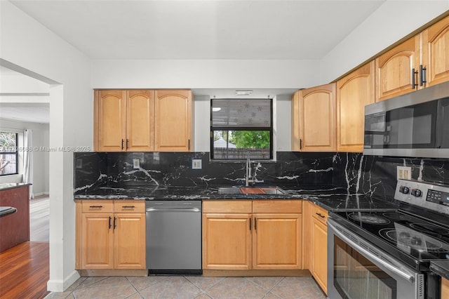 1100 N 31st Ct, Hollywood, FL 33021 - kitchen with stainless steel appliances, a sink, dark stone counters, and backsplash