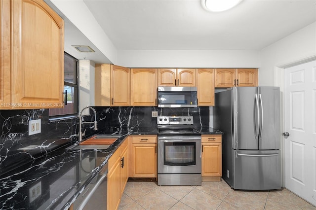 1100 N 31st Ct, Hollywood, FL 33021 - kitchen featuring appliances with stainless steel finishes, a sink, backsplash, dark stone countertops, and light tile patterned flooring