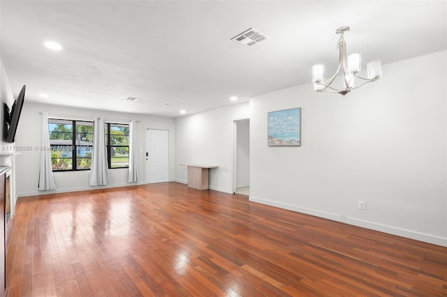1100 N 31st Ct, Hollywood, FL 33021 - unfurnished living room with a chandelier, wood-type flooring, recessed lighting, and baseboards