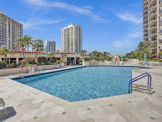 community pool featuring a patio area and a city view