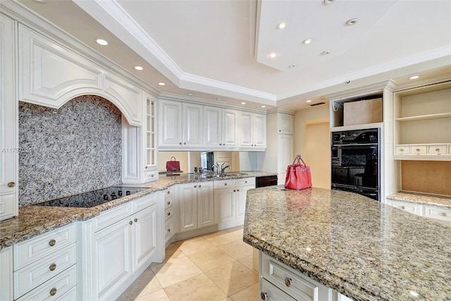 19667 Turnberry Way Unit 16Gr, Aventura, FL 33180 - kitchen with black appliances, decorative backsplash, crown molding, a tray ceiling, and light stone countertops
