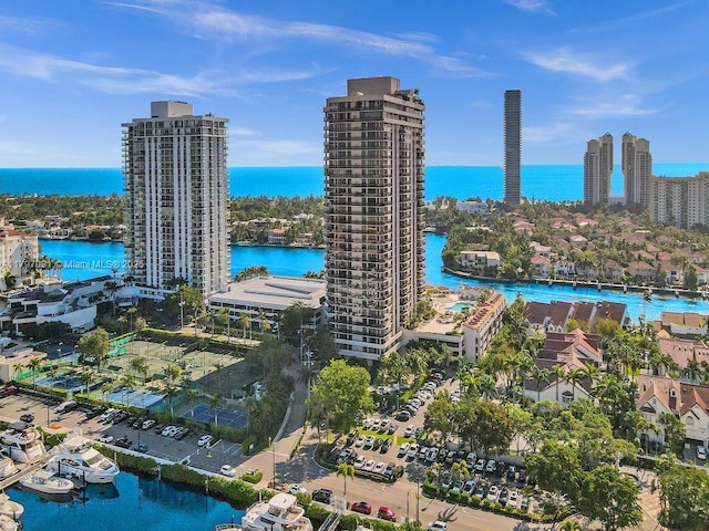 birds eye view of property featuring a city view and a water view