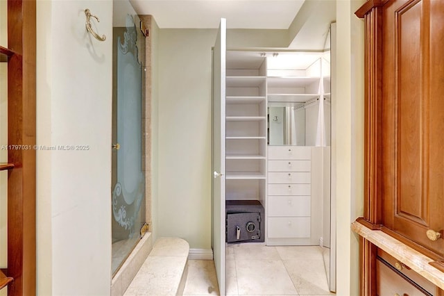 19667 Turnberry Way Unit 16Gr, Aventura, FL 33180 - bathroom featuring tile patterned floors, a stall shower, a spacious closet, and baseboards