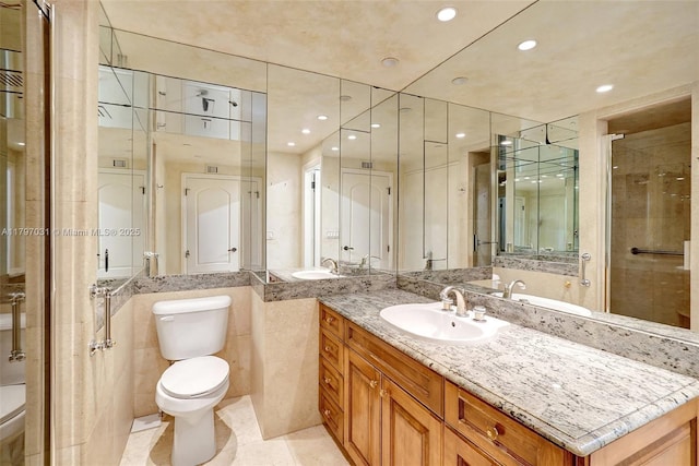 19667 Turnberry Way Unit 16Gr, Aventura, FL 33180 - bathroom featuring toilet, vanity, recessed lighting, a shower stall, and tile patterned floors