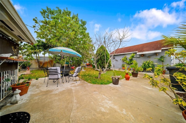 view of patio / terrace with outdoor dining area and fence