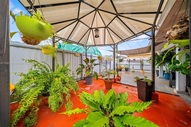 view of patio featuring a fenced backyard and a gazebo