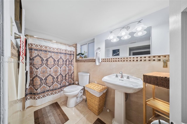 full bathroom featuring curtained shower, tile walls, toilet, and tile patterned flooring
