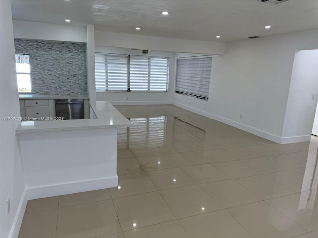 kitchen featuring dishwasher, light tile patterned floors, plenty of natural light, and recessed lighting