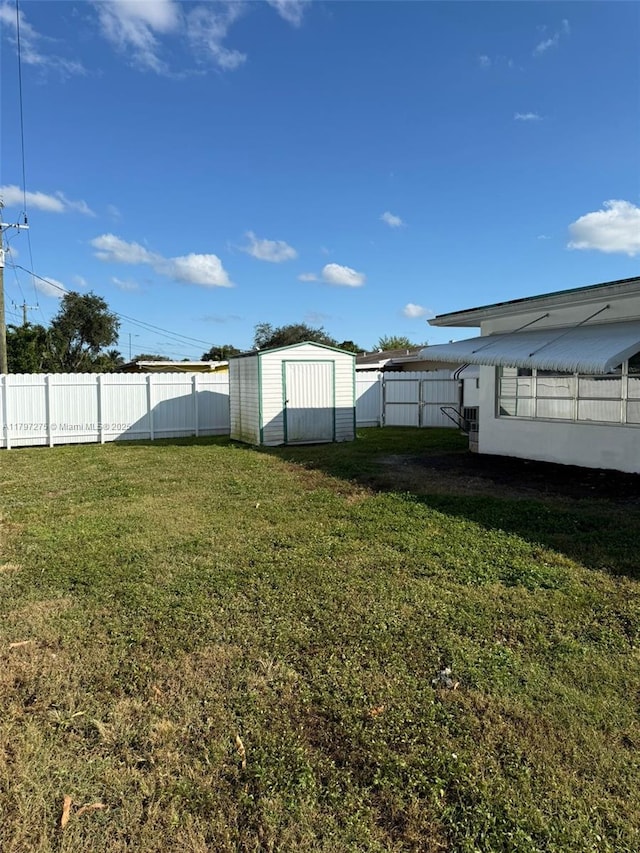 view of yard with a storage shed and an outbuilding