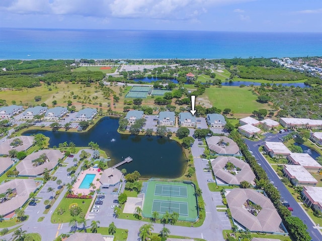 drone / aerial view with a water view and a residential view
