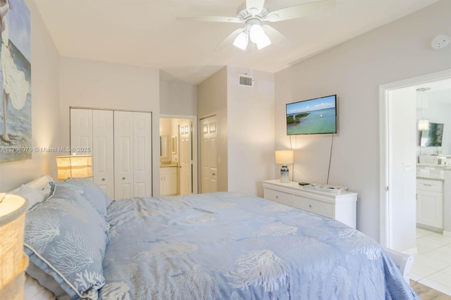 bedroom featuring ceiling fan, connected bathroom, visible vents, and light tile patterned flooring