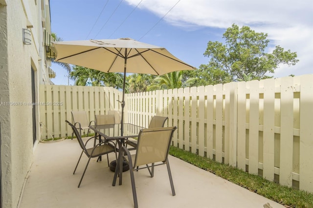 view of patio featuring fence and outdoor dining space