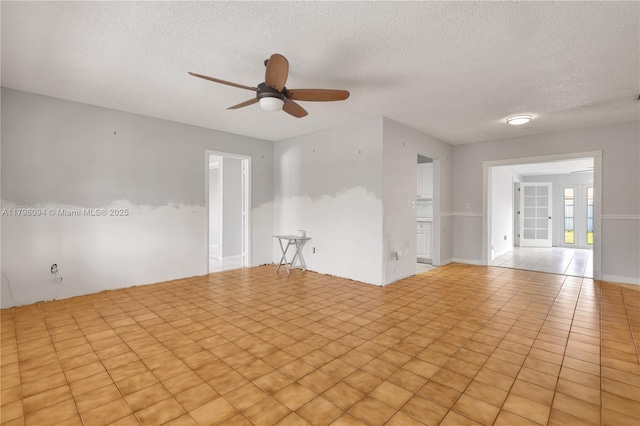 spare room featuring ceiling fan and a textured ceiling