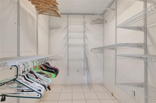 walk in closet with tile patterned flooring