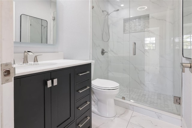bathroom with vanity, toilet, a marble finish shower, and marble finish floor